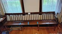 front view of entire long spindle-back bench