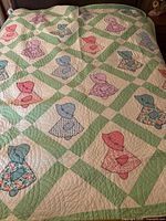Full view of quilt on bed showing pattern and colors