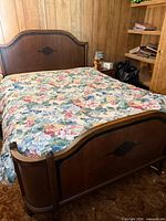 Full view of bed with headboard, footboard, mattress and floral cover