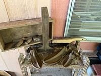 Overall view: shoe last stand, three lasts, hammer, pincers, wooden box