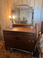 Front view of dresser with attached mirror showing overall style and drawer configuration