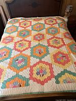 Quilt spread on bed showing full pattern and color