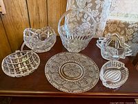Group view of six crystal and glass items on table