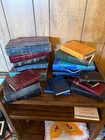 Stack of assorted Bibles on shelf