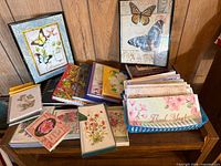 Wide view of cards, books and framed butterfly prints on shelf