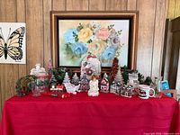 Overall view of entire Christmas décor lot on red cloth showing all items together