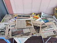 Overall view of newspapers and Disney books on table
