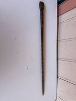 Full length view of carved wooden walking stick