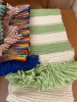 Two striped crocheted shawls with fringe