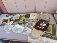 overview of all embroidery supplies, hoops, bibs, booklets on table