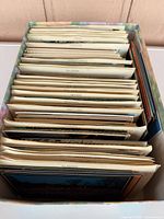 Box filled with organized stacks of postcards