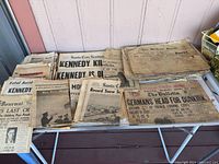 Overall view of multiple stacks of newspapers on a table