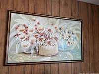 Full view of framed floral painting on wood-panel wall