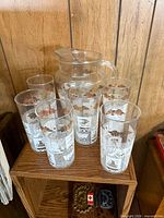 Pitcher with five tumblers on shelf