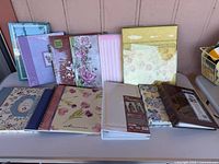 Ten assorted unused photo albums displayed on table