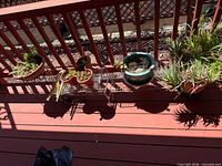 Overview showing all planters aligned on deck railing with two wire stands