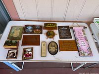 All twelve plaques and pictures laid out on table