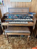 Front view of Hammond organ with bench and control panel