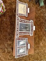 Overview of three matching Swedish wood frames on table