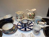 Group shot of all ten porcelain and ceramic items on stovetop