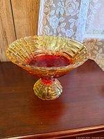 Full view of two-tone pedestal glass compote bowl on table