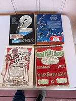 Four catalogs laid out on table showing front covers