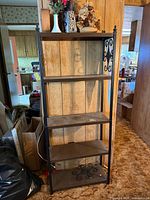 Full view of black metal bookcase with five shelves