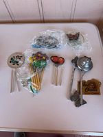 Overview of five wind chimes on table, assorted designs visible