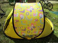 Assembled yellow pop-up tent with insect and butterfly print