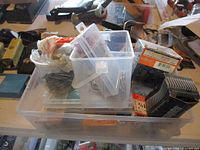 overall view of plastic bin with assorted fastener boxes and containers