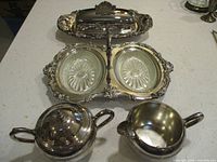 Top view showing divided server with glass inserts, butter dish lid removed, sugar and creamer