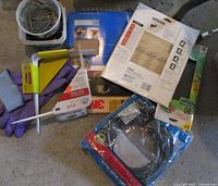 overview of all items: nails, gloves, hacksaw, hex key, sanding materials, drain hose