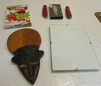 Overall layout showing knives, card game, keychain, frame and trivet front