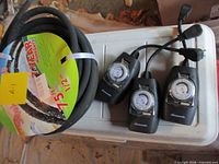 Coiled soaker hose and three hose timers displayed on cooler