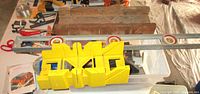 Overview showing yellow plastic miter box, wood miter box, aluminum level