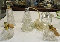 Group shot of all six glass and crystal perfume bottles
