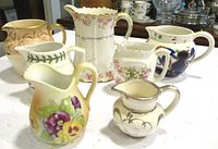 Group of six assorted pitchers displayed together