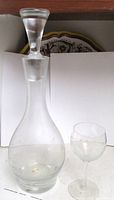 Decanter with stopper seated beside matching wine glass