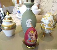 Group shot of all four items: Wedgwood vase, porcelain egg trinket box, covered vase, wax Easter candle