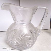 Front view of clear cut crystal pitcher showing pinwheel pattern