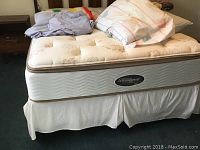 Full view of mattress and box spring with bedding accessories