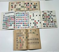 Five open albums showing stamp pages