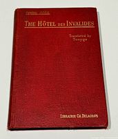 Front cover showing title, author, translator, publisher on red cloth board
