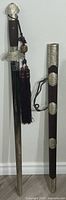 Sword sheathed next to scabbard showing full length and fittings