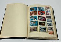Album open showing filled page of Soviet commemorative stamps