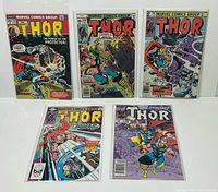 All five bagged Thor comics laid out, issue numbers visible