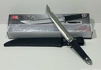 Knife, sheath and box displayed together