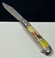 Knife open showing RCMP graphic handle side