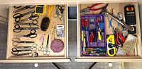 Open drawers showing scissors, screwdrivers, pliers, cutters, brushes and accessories
