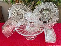Group view of lead crystal serving pieces on red cloth